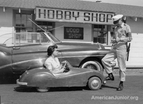 American Junior Jaguar with woman passenger at Air Base in Portland Oregon 1955